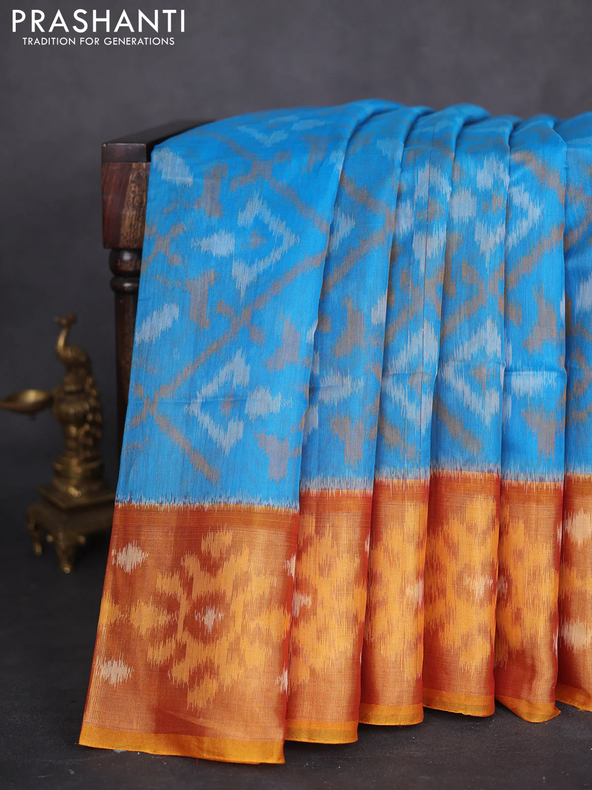 Ikat silk cotton saree blue and rustic orange with allover ikat weaves and long zari woven ikat border