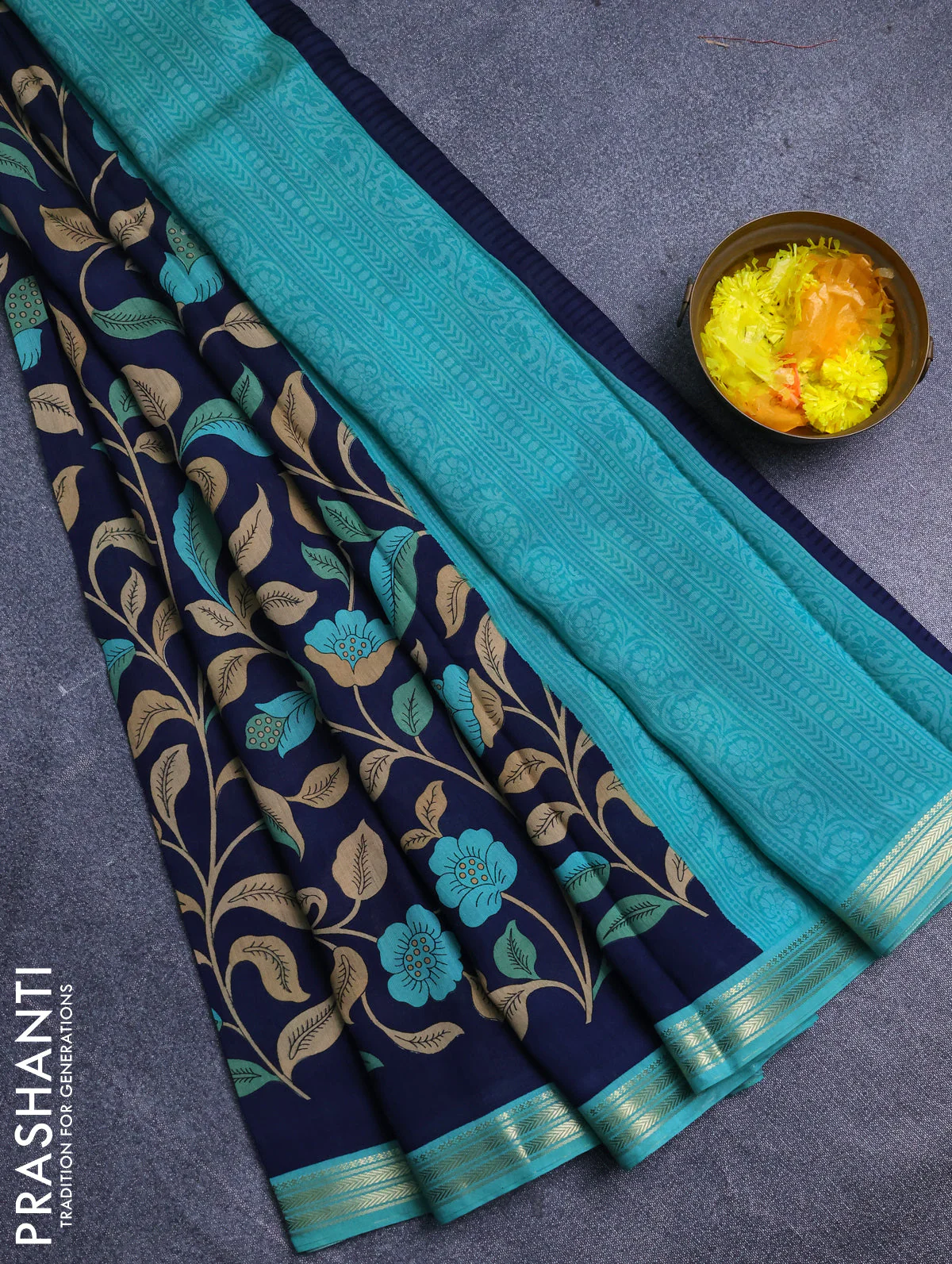 Muslin silk saree navy blue and teal green with allover prints and zari woven border