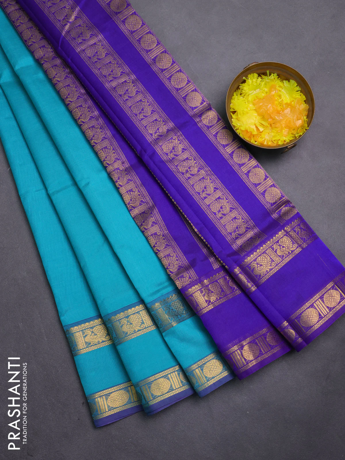 Silk cotton saree teal blue and violet with plain body and rettapet zari woven border